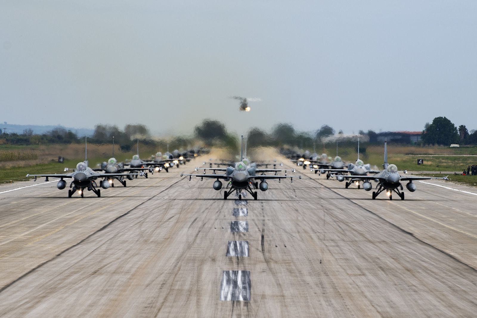 A line of F-16s taxiing together during an elephant walk